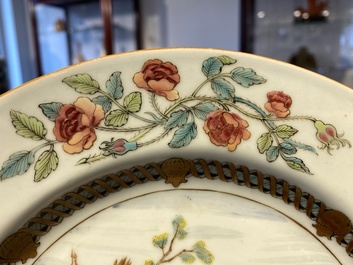 A pair of Chinese famille rose plates with peasants playing cards in the style of the painter David Teniers II, Qianlong