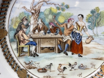 A pair of Chinese famille rose plates with peasants playing cards in the style of the painter David Teniers II, Qianlong