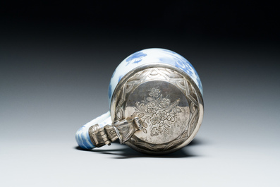 A Dutch Delft blue and white chinoiserie jug with silver lid, 17th C.