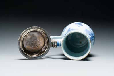 A Dutch Delft blue and white chinoiserie jug with silver lid, 17th C.