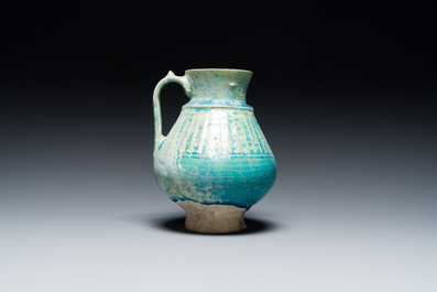 A turquoise-glazed jug, Kashan, Persia, 13th C.
