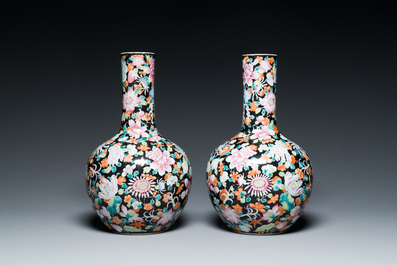 Paire de vases de forme bouteille en porcelaine de Chine famille rose &agrave; d&eacute;cor millefleurs sur fond noire, marque de Qianlong, R&eacute;publique