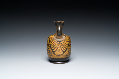 An Etruskian 'aryballos' portrait ewer and a 'patera' dish with black geometrical design, 4th C. b.C.