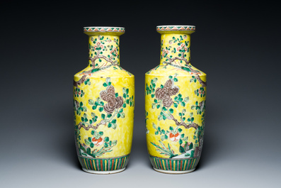A pair of Chinese yellow-ground famille verte rouleau vases, 19th C.