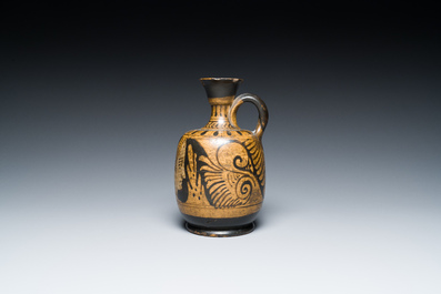 An Etruskian 'aryballos' portrait ewer and a 'patera' dish with black geometrical design, 4th C. b.C.