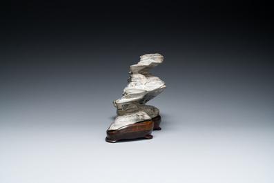 A Chinese grey lingbi stone scholar's rock on wooden stand, 19/20th C.