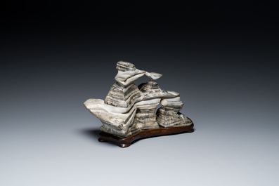 A Chinese grey lingbi stone scholar's rock on wooden stand, 19/20th C.