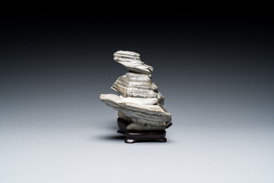 A Chinese grey lingbi stone scholar's rock on wooden stand, 19/20th C.