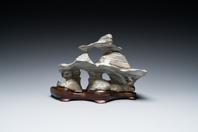 A Chinese grey lingbi stone scholar's rock on wooden stand, 19/20th C.