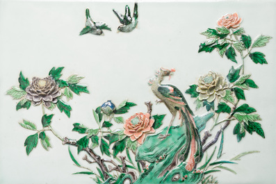 A Chinese relief-decorated famille verte 'peacock' plaque in a fine carved hongmu wooden frame, 19th C.