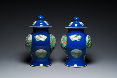 A pair of Chinese powder-blue-ground famille verte vases and covers, 19th C.