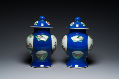 A pair of Chinese powder-blue-ground famille verte vases and covers, 19th C.