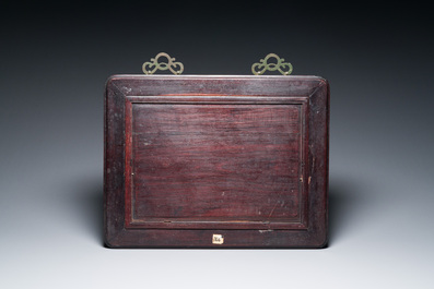 A Chinese relief-decorated famille verte 'peacock' plaque in a fine carved hongmu wooden frame, 19th C.