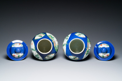 A pair of Chinese powder-blue-ground famille verte vases and covers, 19th C.