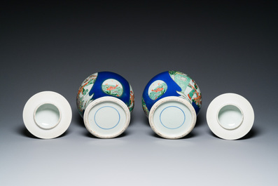 A pair of Chinese powder-blue-ground famille verte vases and covers, 19th C.