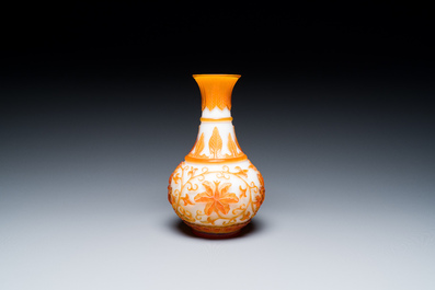 A Chinese overlay Beijing glass bottle vase with lotus scrolls in yellow on white, 19t/20h C.