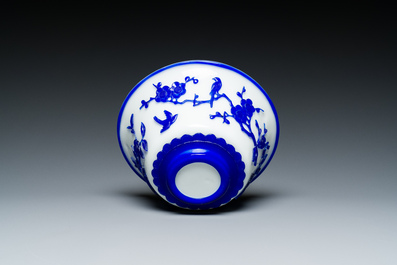 A Chinese overlay Beijing glass 'magpie and plum blossom' bowl in blue on white, 19th C.
