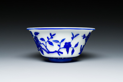 A Chinese overlay Beijing glass 'magpie and plum blossom' bowl in blue on white, 19th C.