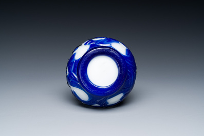 A Chinese overlay Beijing glass bottle vase with lotus scrolls in blue on white, 19th C.