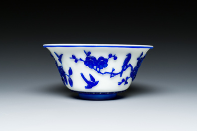 A Chinese overlay Beijing glass 'magpie and plum blossom' bowl in blue on white, 19th C.