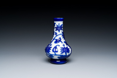 A Chinese overlay Beijing glass bottle vase with lotus scrolls in blue on white, 19th C.