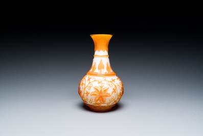 A Chinese overlay Beijing glass bottle vase with lotus scrolls in yellow on white, 19t/20h C.