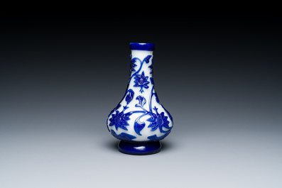 A Chinese overlay Beijing glass bottle vase with lotus scrolls in blue on white, 19th C.
