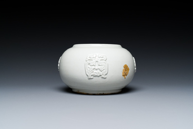 A Chinese white-glazed relief-molded bowl, Qianlong mark, 19th C.