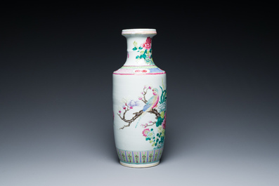 A Chinese famille rose rouleau vase with a parrot among blossoming branches, 19th C.