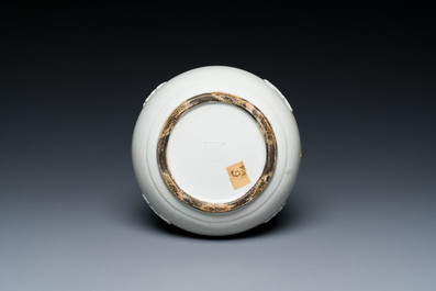 A Chinese white-glazed relief-molded bowl, Qianlong mark, 19th C.
