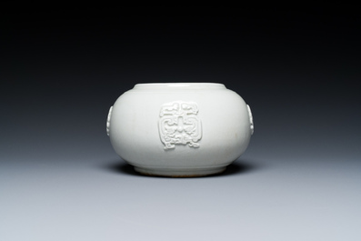 A Chinese white-glazed relief-molded bowl, Qianlong mark, 19th C.