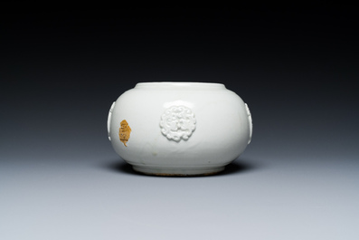 A Chinese white-glazed relief-molded bowl, Qianlong mark, 19th C.