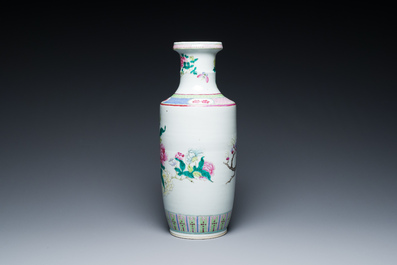 A Chinese famille rose rouleau vase with a parrot among blossoming branches, 19th C.