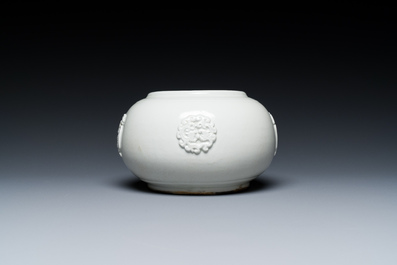 A Chinese white-glazed relief-molded bowl, Qianlong mark, 19th C.