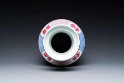 A Chinese famille rose rouleau vase with a parrot among blossoming branches, 19th C.