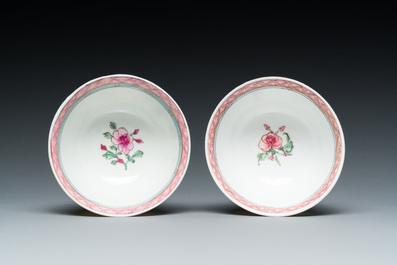 A pair of Chinese famille rose cups and saucers with a lady and a boy, Yongzheng