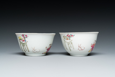 A pair of Chinese famille rose cups and saucers with a lady and a boy, Yongzheng