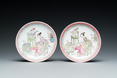A pair of Chinese famille rose cups and saucers with a lady and a boy, Yongzheng