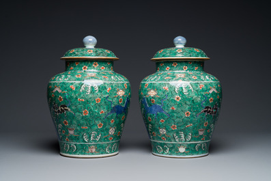 A pair of Chinese famille verte 'galloping horses' vases and covers, 19th C.