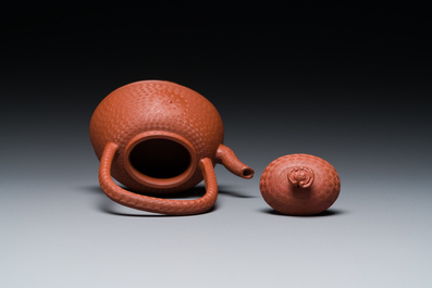 Een Chinese Yixing steengoed theepot met gekerfd decor van chrysanten, Kangxi