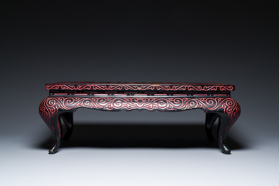 A Chinese rectangular carved red and black lacquer table, 'kang', Xuande mark, 20th C.