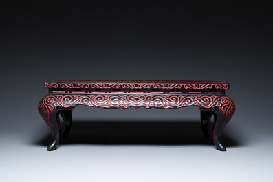 A Chinese rectangular carved red and black lacquer table, 'kang', Xuande mark, 20th C.