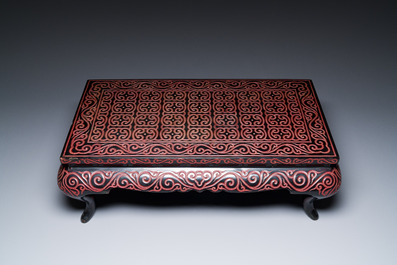 A Chinese rectangular carved red and black lacquer table, 'kang', Xuande mark, 20th C.