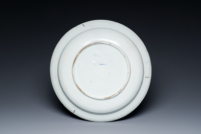 A large blue and white Dutch Delft dish with refined design of gentlemen in a landscape, 18th C.
