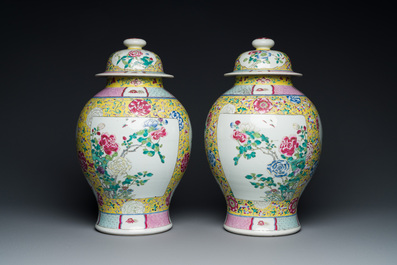 A pair of Chinese yellow-ground famille rose vases and covers, 19th C.