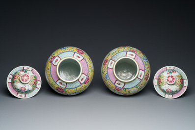 A pair of Chinese yellow-ground famille rose vases and covers, 19th C.