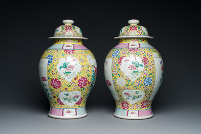 A pair of Chinese yellow-ground famille rose vases and covers, 19th C.
