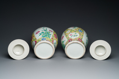 A pair of Chinese yellow-ground famille rose vases and covers, 19th C.