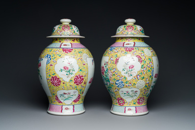 A pair of Chinese yellow-ground famille rose vases and covers, 19th C.