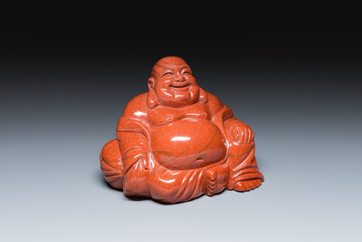 A Chinese emerald green jadeite 'birds' group and a goldstone sculpture of Buddha, 19/20th C.
